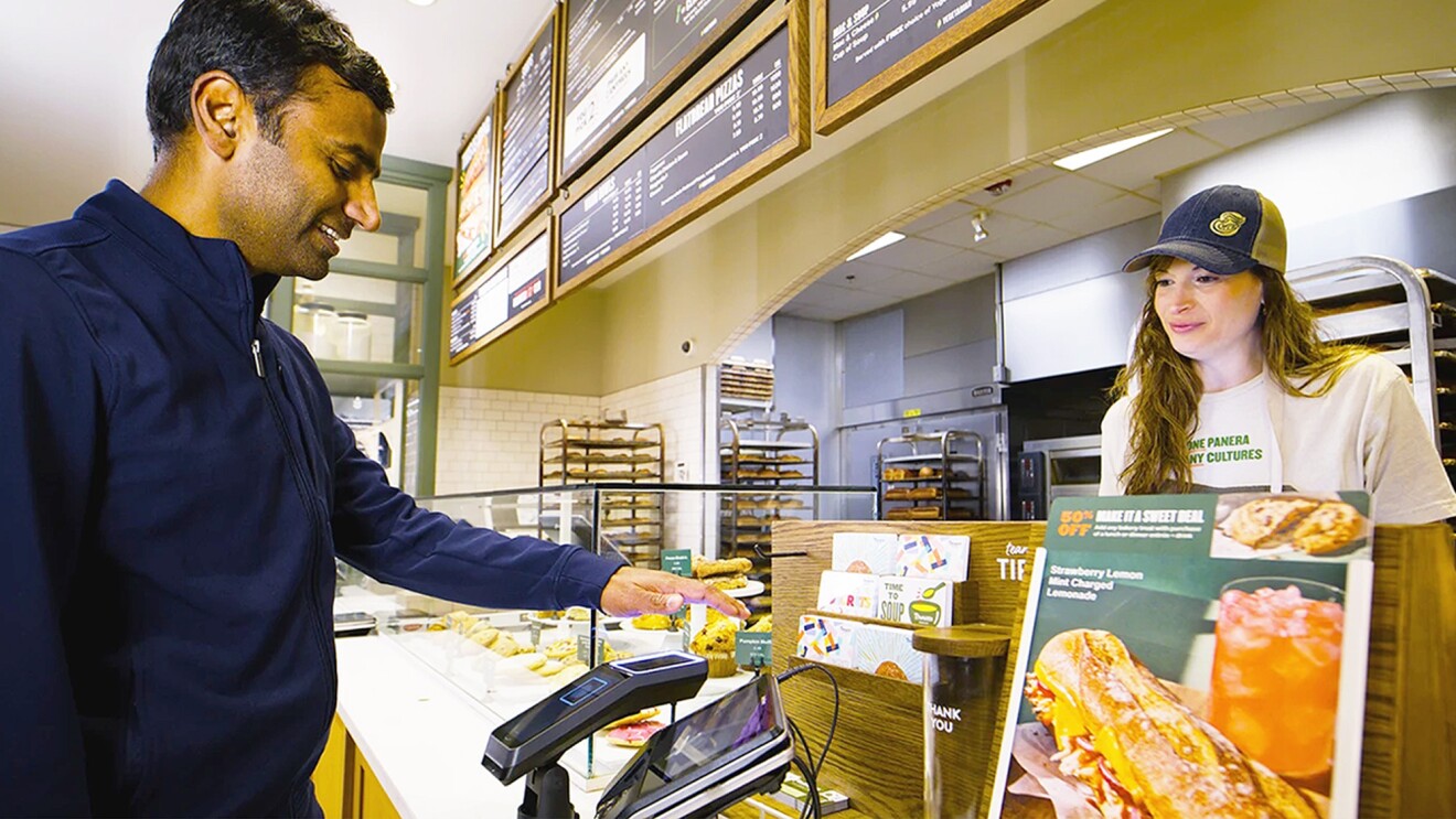 A man pays using Amazon One at a Panera store.