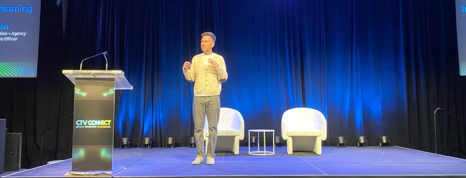 A person standing on a stage AI-generated content may be incorrect.