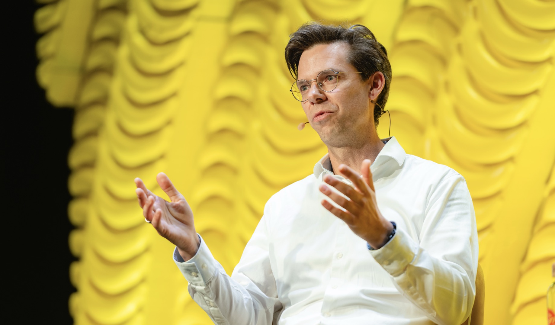 A person with a microphone AI-generated content may be incorrect.